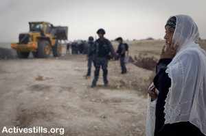  A Bedouin woman looks on as Israeli soldiers demolish  her village of Al Arakib again 13/9/2010